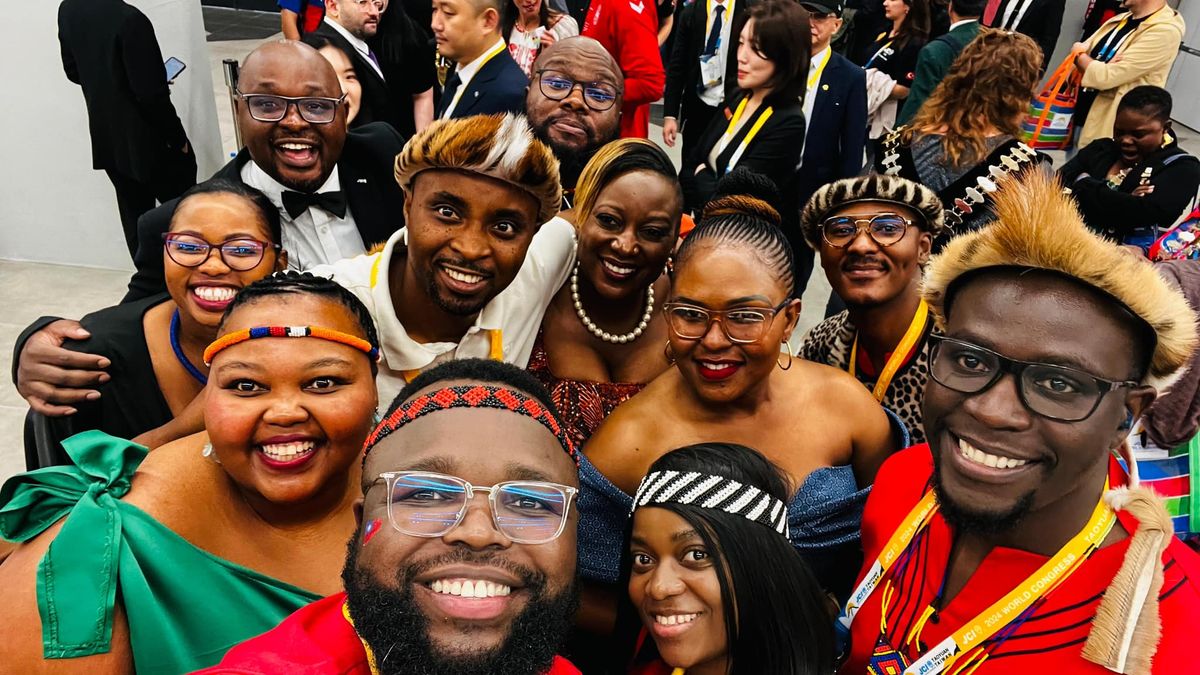 Members in traditional attire taking a group selfie